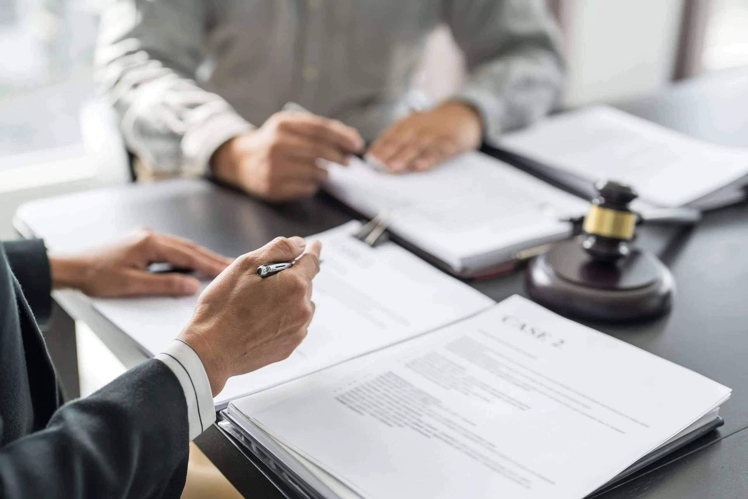 lawyer-legal-counsel-presents-client-signed-contract-with-gavel-legal-law-justice-lawyer-business-partnership-meeting-concept-scaled.webp